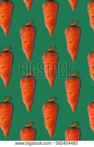 Ugly Carrots Regular Pattern With Shadows Pastel Background. Big Deformed Vegetables On Pastel Backg