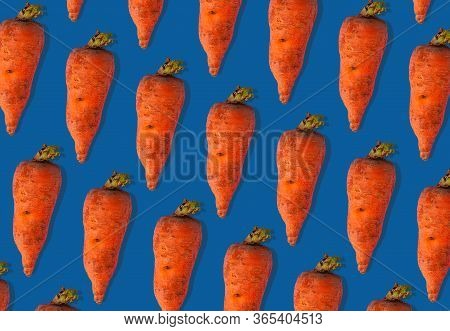 Ugly Carrots Regular Pattern With Shadows Pastel Background. Big Deformed Vegetables On Pastel Backg