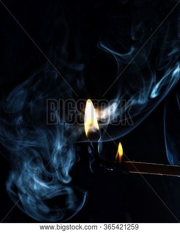 Creative And Mystic Studiophotography With Matches And Smoke