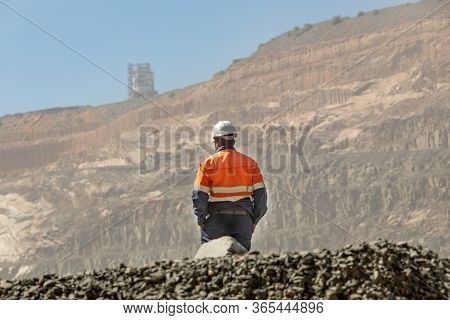 African worker in an open pit diamond mine , in Botswana