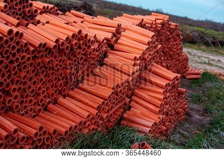 Ceramic Drainage Pipes Of Red Color For The External Sewerage. Traditional Material, Inside The Shap