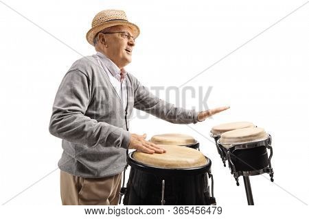 Elderly man playing conga drums isolated on white background