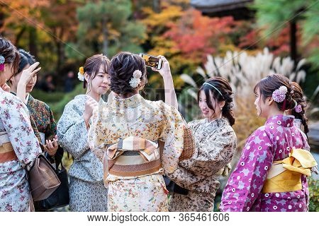 Women Group Tourists In Japanese Kimono Enjoying With Colorful Leaves In Ginkakuji Temple, Autumn Fo