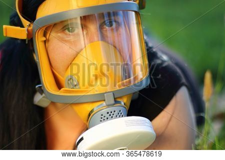Woman in protection mask on a meadows. Allergy and infection control concept. Hayfever or covid-19 hazard.