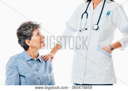 Senior Patient Looking At The Doctor And Waiting Advice - Isolated On White.