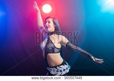 Girl Dancing Belly Dance, Fusion Or Tribal. A Woman In A Beautiful Costume Demonstrates Charming And