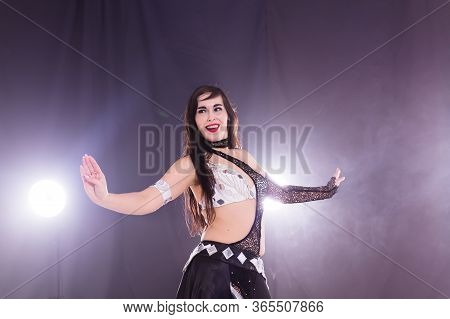 Girl Dancing Belly Dance, Fusion Or Tribal. A Woman In A Beautiful Costume Demonstrates Charming And