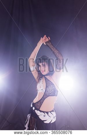 Girl Dancing Belly Dance, Fusion Or Tribal. A Woman In A Beautiful Costume Demonstrates Charming And