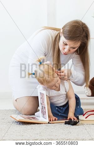 Hearing Aid In Baby Girls Ear. Toddler Child Wearing A Hearing Aid At Home. Disabled Child, Disabili