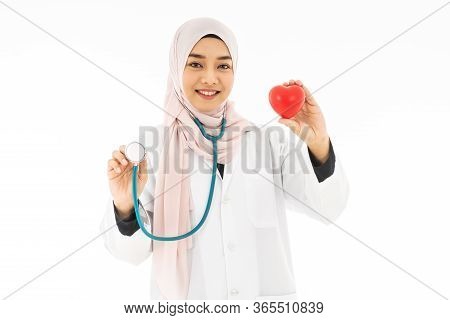 Portrait Of Beautiful Young Muslim Woman Doctor Shows A Red Heart On The Left Hand And Wearing A Ste