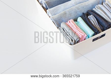 Box With Brught Socks, Closeup. Sort Up Socks. White Background. Basket.