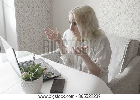 Close-up Of Young Woman Using Laptop On Remote Work. A Girl In A White Shirt. Embrassed Female. Girl