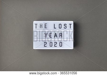 Falling Growth In Business, Composition With Lightbox With The Lost Year 2020 Slogan On Grey Paper B