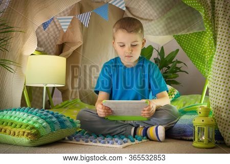 Cute Boy, Playing On Tablet And Telephone In Campside, In The Tent