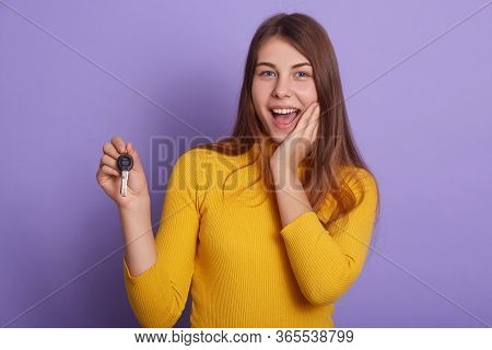 Closeup Portrait Of Happy Smiling Woman, Holding Key From New Car, Yelling Happily, Wearing Yellow C
