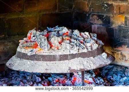 Sac, Metalic Lid Covered By Ashes And Live Coals