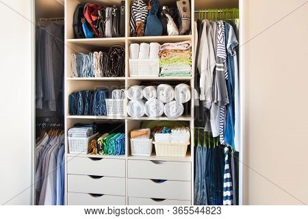 Clothing Lying In The Drawer In The Wardrobe. T-shirts For Women. The Order In The Wardrobe. Beige W