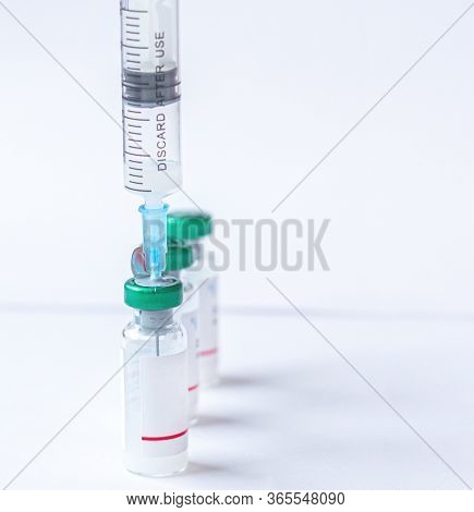 Syringe With A Vaccine Coronavirus, Covid-19, Ncov 2019 And Flu Vaccine On White Background. Medicin