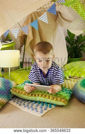 Cute Boy, Playing On Tablet And Telephone In Campside, In The Tent