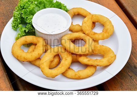 A Onion Rings On A Plate On A Table