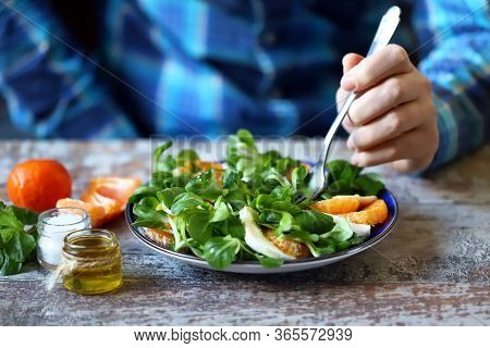 Chef Preparing A Healthy Salad. Male Hand Mixed Salad With Mozzarella And Tangerine. Salad A La Capr