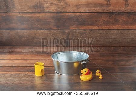 Background For Baby Photo Shoot. Bath Time With Basin And Ribber Duck. Shampoo And Bubbles.