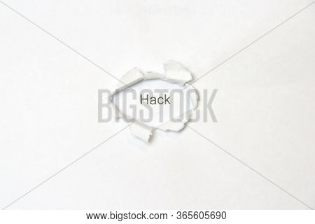 Word Hack On White Isolated Background, The Inscription Through The Wound Hole In The Paper. Stock P