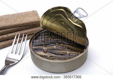 Open Canned With Sprots And Crispy Breads On A White Isolated Background