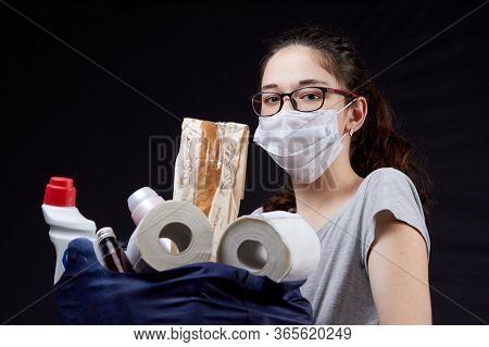 Young Woman In Protective Mask With A Bag Full Of Groceries From The Supermarket