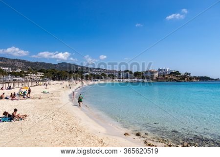 Palmanova, Mallorca, Spain - April 13, 2019: Tourists Taking A Sunbath On The Beach Platja De Palman