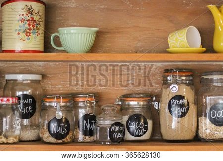 Wooden Antique Kitchen Hutch With Jars Of Baking Ingredients And Retro Crockery