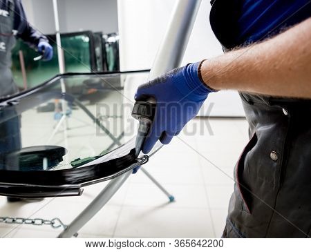 Automobile Special Workers Replacing Windscreen Of A Car In Auto Service