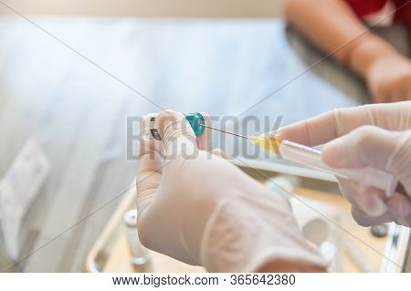Doctor Hand With Syringe Prepare Injection Medicint Or Vaccine To Patient Close Up On Needle Vial
