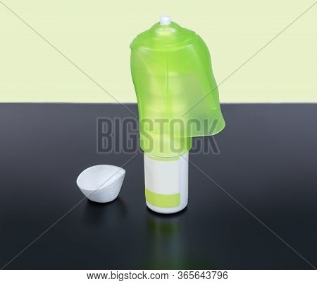 Eye Drops In The Small Bottle With Pressure Dispenser And Removed Protective Cap On The Dark Matte S