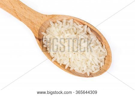 Uncooked Long Grain Basmati Rice In The Wooden Spoon On A White Background, Top View Close-up