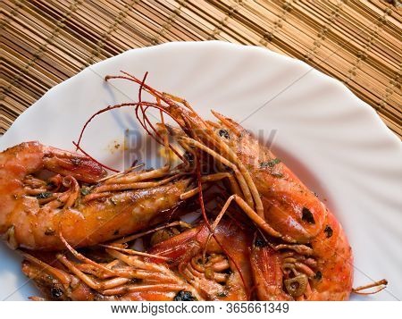 A Fried Lobster On A White Plate, A Straw Lining Under Plate, Garlic, Close Up