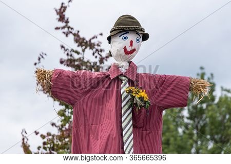 Straw Doll As A Funny Scarecrow And Garden Decoration