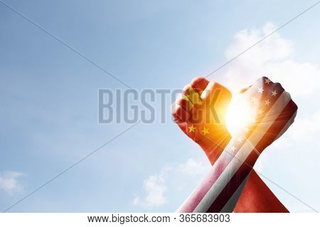Usa And China Print Screen On Hand Fist And Wrestling With Blue Sky And Sunlight. United States Of A