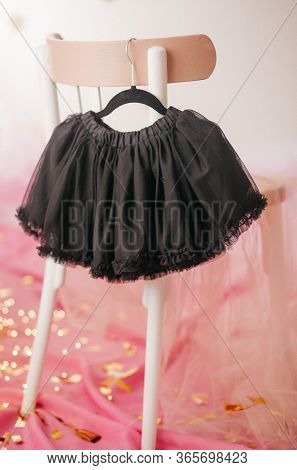 Stock Photo - Child Skirt On Hanger On Pink Background