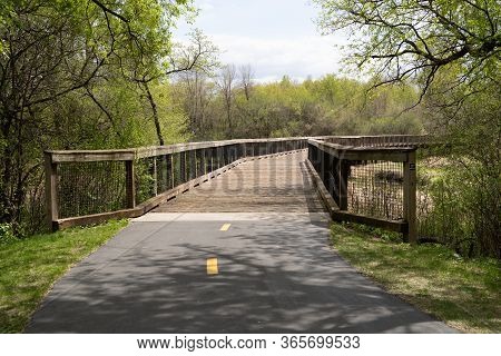 Pedestrian Bridge Over A Creek And Marsh Wetland In Elm Creek Park Reserve - Maple Grove, Minnesota