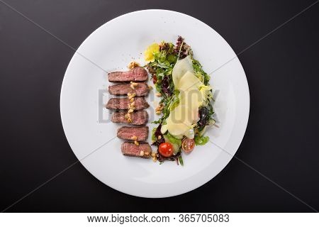 Grilled Roast Beef Salad Served With Arugula And Parmesan Cheese