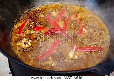 National Uzbek Dish Pilaf, Pilaw, Plov, Rice With Meat In Big Pan. Cooking Process In A Cauldron On 