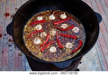 National Uzbek Dish Pilaf, Pilaw, Plov, Rice With Meat In Big Pan. Cooking Process In A Cauldron On 