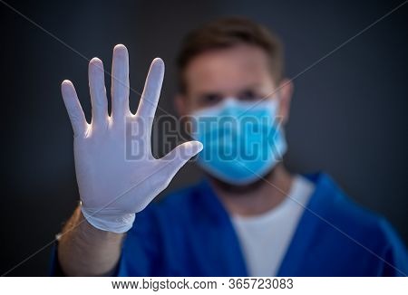 Covid-19 Outbreak. Help To Stop The Virus Spread. Male Doctor Or Nurse Wearing Face Surgical Mask An