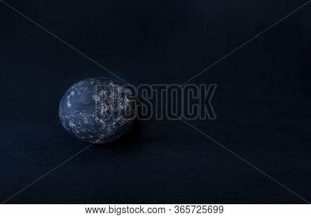 On A Black Background An Egg Of Black Color Asymmetrically Placed Egg
