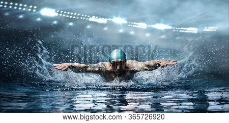Man Is Swimming Breaststroke. Water Sports Concept. Mixed Media