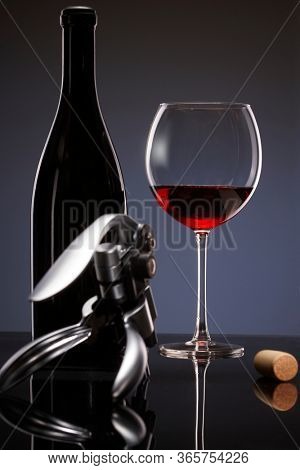 Elegant photo of a glass of red wine on dark background.