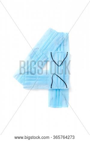 Figure 4, four handmade from medical antibacterial protective blue face masks on a white background, copy space. Creative typeface for making up new numerical information.