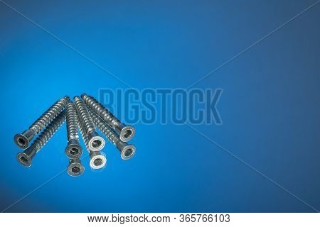 Countersunk Wood Screws On A Blue Background.