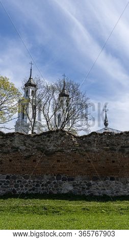 Ludza Medieval Castle Ruins On A Hill Between Big Ludza Lake And Small Ludza Lake And The Roman Cath